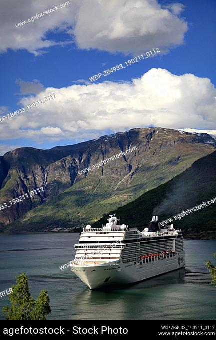 View of the Cruise ship MSC Orchestra, leaving the harbour at the town of Flam, where the famous Flam Railway starts from, Aurlandsfjorden Fjord
