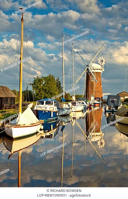 England, Norfolk, Horsey, Relections of Horsey Windpump and boats in Horsey Mere on the Norfolk Broads