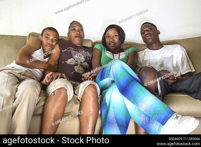 Scared family sitting on sofa