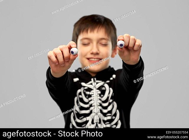 boy in halloween costume with eyeball candies