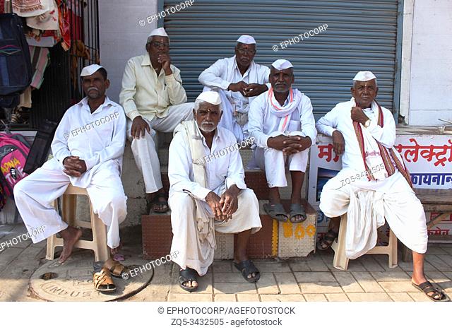 PUNE, MAHARASHTRA, INDIA, 25 June 2019 Warkaris or Pilgrims sitting on street, Alandi devachi, Pune, Maharashtra