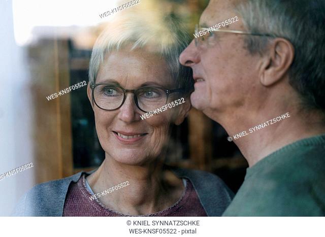 Confident senior couple looking out of window