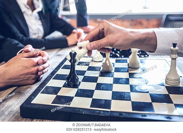 Business people playing chess