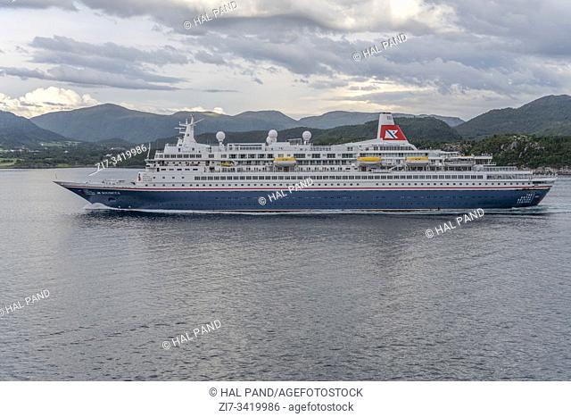 AKURA, NORWAY - July 18 2019: cruiser sailing in fjord water, shot under bright summer cloudy light on july 18, 2019 at Akura island, Norway