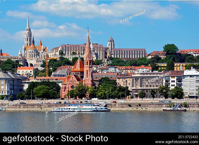 View across the river Danube to the historic buildings in Buda with Matyas church, Fishermen's Bastion and Calvin's church in Budapest - Hungary
