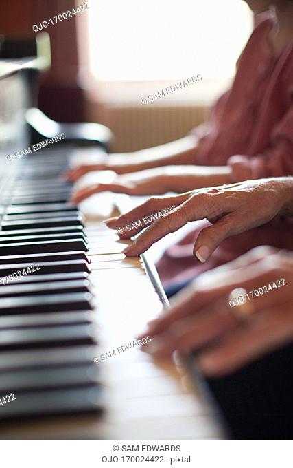 Close up of hands on piano