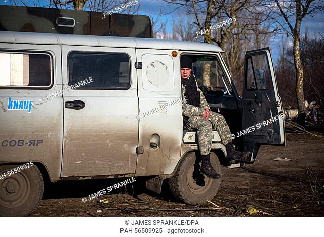 Berdyansk Oblast, Ukraine - March, 7, 2015: An Azov battalion soldier waits around in his van during firing exercises near the port city of Mariupol
