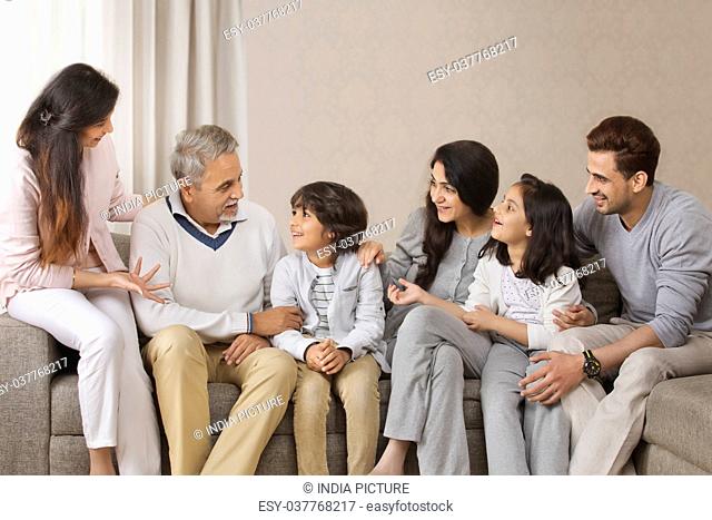 Happy multi-generation family sitting on sofa