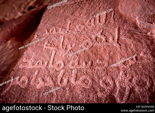 Ancient Petroglyph inscriptions at Khazali canyon at Wadi Rum desert in Jordan, a popular stop on jeep tours in in Wadi Rum desert