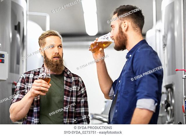 men drinking and testing craft beer at brewery
