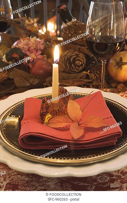 Festive place-setting with candle for Thanksgiving USA