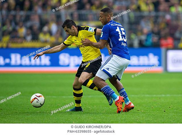 Dortmund's Henrikh Mkhitaryan (l) and Schalke's Dennis Aogo (r) compete for the ball in the air during the German Bundesliga football match between Borussia...