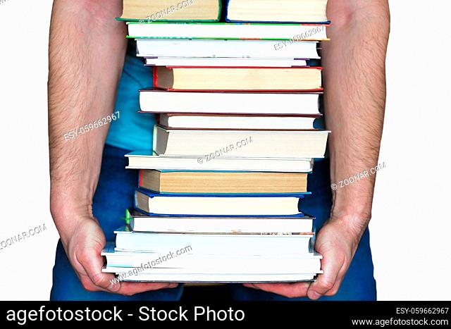 It is a stack of books in a man's hands, isolated on a white background. The concept of education and the study of sciences