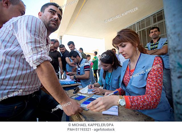 A refugee is registered for the distribution of food in a Diakonie Project at the A`shtar School in Erbil, Iraq, 16 August 2014