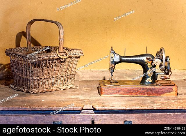 Ootmarsum, The Netherlands - August 18, 2019: Agricultural museum with reed basket and old Singer sewing machine