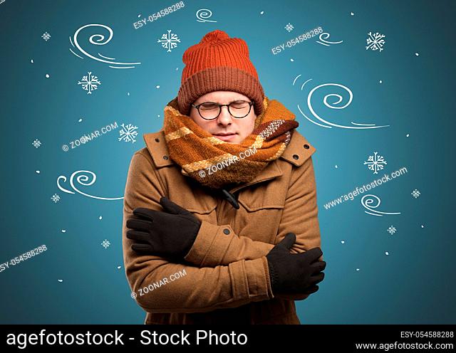Young hipster frozen boy with doodled snowflakes and windy concept
