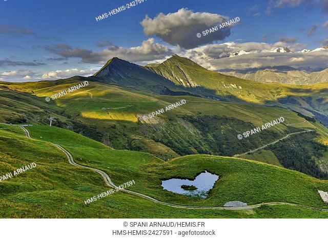 France, Savoie, Beaufortain, Hauteluce, heart-shaped pond in the pastures at sunset