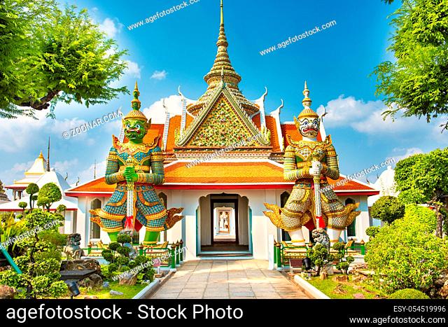 View to beautiful gates of Ordination Hall with statues of Giants, demon guardians. Wat Arun temple, Bangkok, Thailand