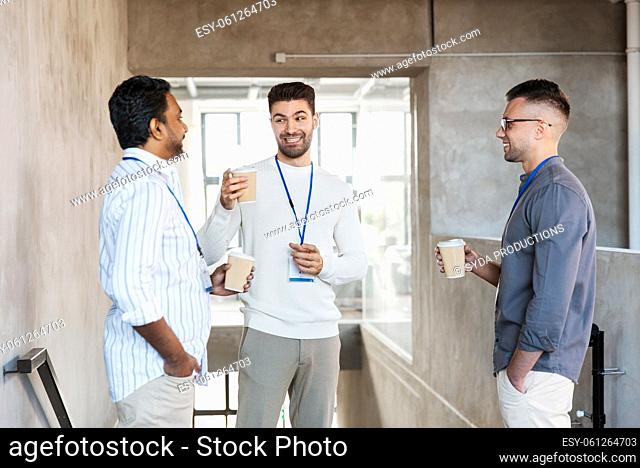 businessmen drinking takeaway coffee at office