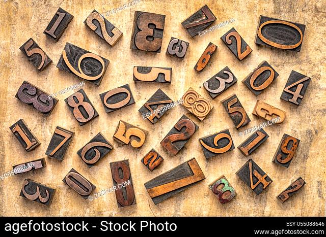 pile of random numbers in letterpress wood type against textured bark paper