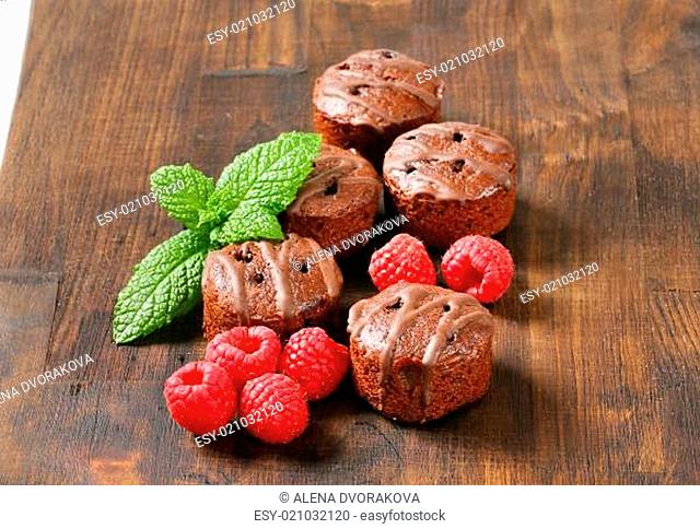 Mini chocolate cakes on wooden background