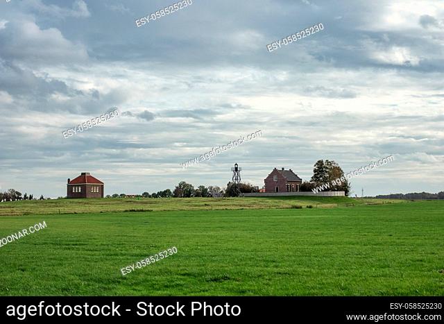 Houses of former island Schokland in Dutch countryside of Noordoostpolder with dramatic autumn sky