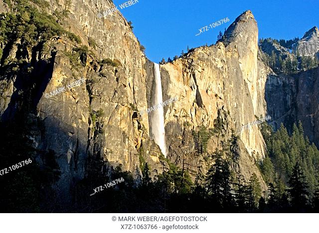 Bridalveil Falls and Leaning Tower at sunset in Yosemite Valley at Yosemite National Park in California USA