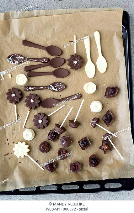Homemade pralines and chocolate lollies on baking paper