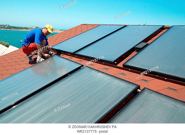 Worker installs solar panels
