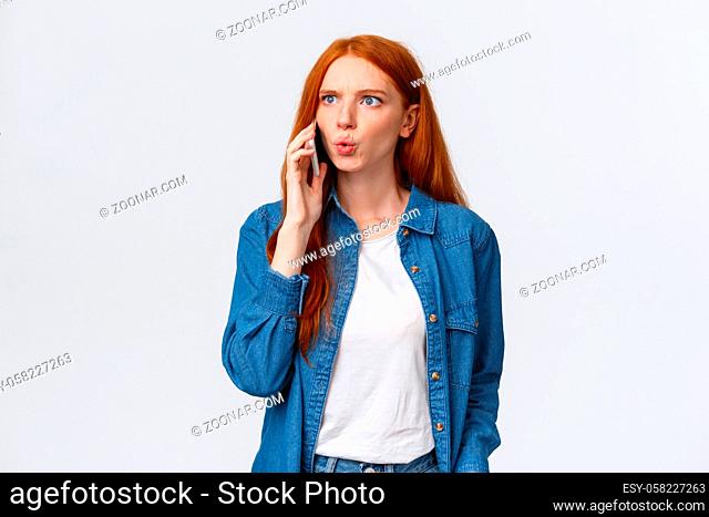 You say what. Intense and frustrated, confused redhead woman getting tensed and distressed hearing some bad news on phone