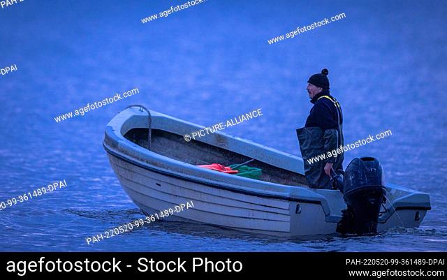 20 May 2022, Mecklenburg-Western Pomerania, Ahlbeck: One of the last beach fishermen heads for his fishing nets in the Baltic Sea off the island of Usedom in...