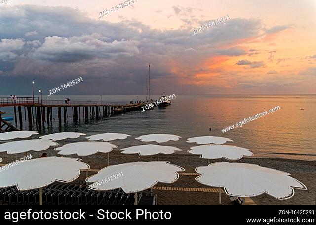View of evening sunset sky from the empty beach of the resort town of Sudak. Crimea