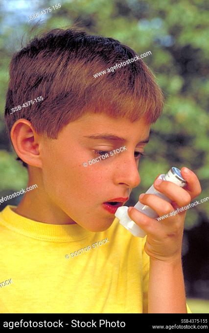 Young Boy Uses Inhaler to Treat Asthma