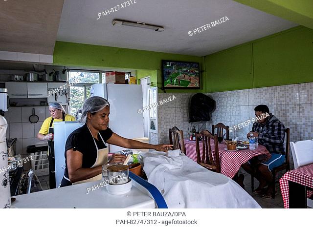Angela Maria Carneiro Barbosa (front) and Antonia Lima (back) working in the restaurant Visual in the favela Rocinha, one of the biggest in Rio with 250