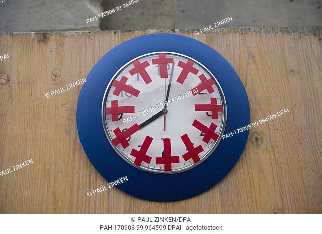 A clock with twelve crosses can be seen at the memorial site for victims of the Breitscheidplatz terrorist attack in Berlin, Germany, 8 September 2017