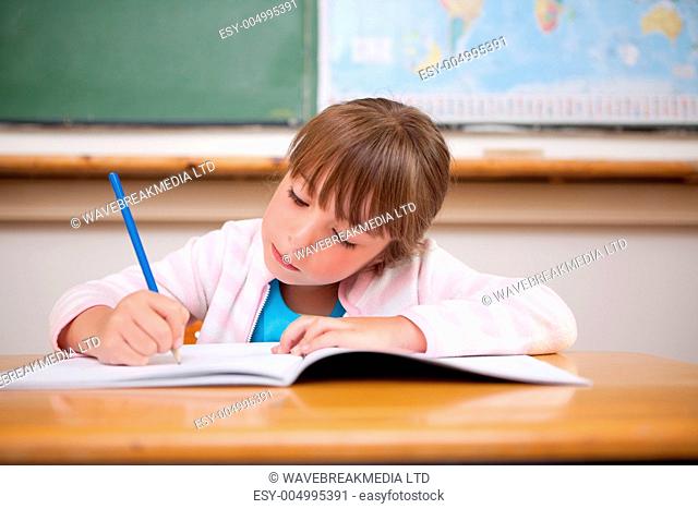 Focused girl writing