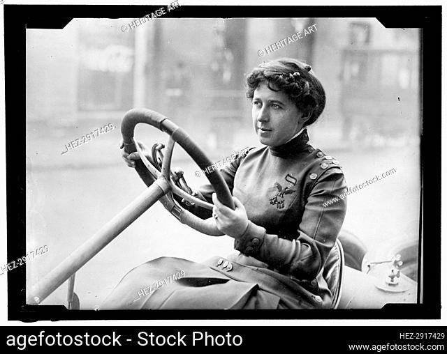 Race car driver Joan Newton Cuneo, seated in racing car, facing left, between 1910 and 1917. Creator: Harris & Ewing