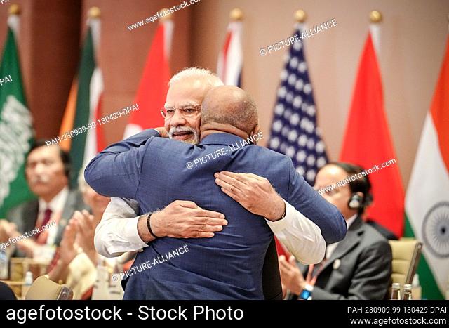 09 September 2023, India, Neu Delhi: Narendra Modi (l), Prime Minister of India, hugs Azali Assoumani of the African Union (AU) at the G20 Summit during the...