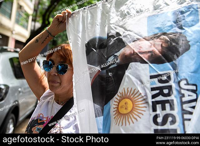 19 November 2023, Argentina, Buenos Aires: A supporter of libertarian populist Javier Milei cheers at the Almagro campus of the National Technological...