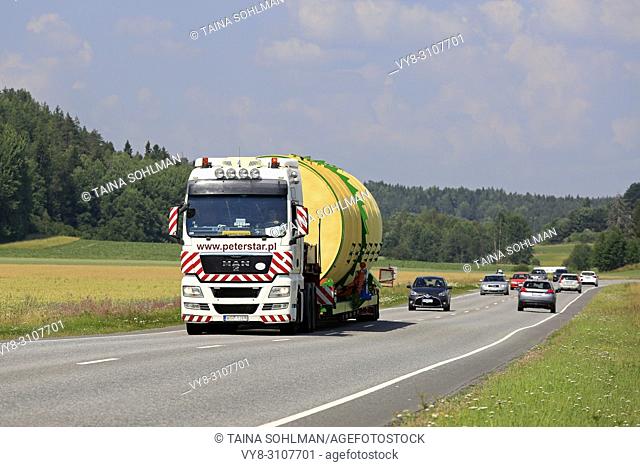 Wide load transport of a silo by MAN TGX 26. 540 semi trailer of Peter-Star, Poland on the road in South of Finland. Salo, Finland - July 27, 2018