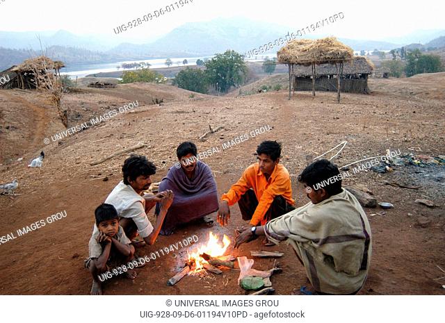 Villagers In Sikka Village On The Gujarat Side Warm Themselves At Dawn Time, With The Narmada River Seen In The Backdrop