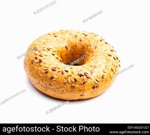 Whole grain baked bagel isolated on white background