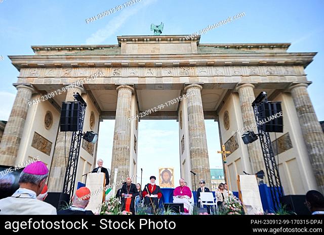12 September 2023, Berlin: Heinrich Bedford-Strohm (l), regional bishop of the Evangelical Lutheran Church in Bavaria, speaks in front of the Brandenburg Gate...