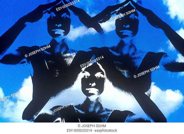 Special effects composite of dancer posing silhouetted against blue cloudy sky