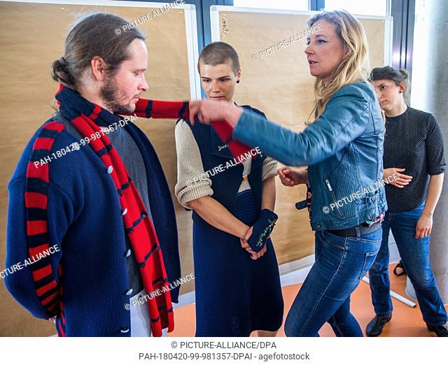 20 April 2018, Germany, Rostock: Fashion designer Jette Joop (r) looks at a costume design from Marlene Schroeder worn by two models at the competition...
