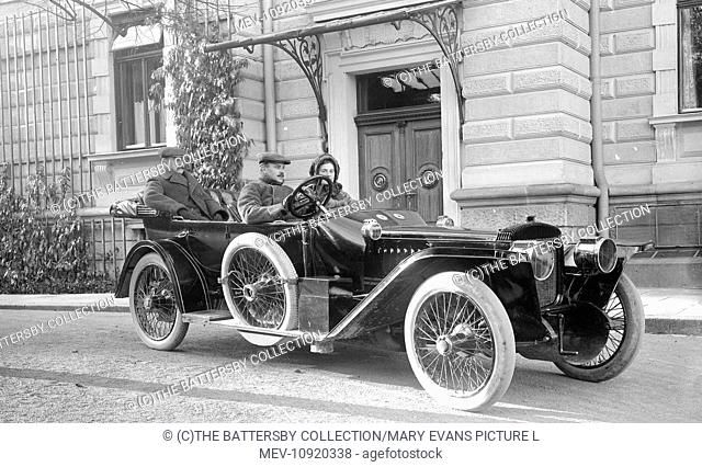 Daimler car and passengers in Vienna, 1911. The driver is Fritz Huckel, hat manufacturer, and beside him is his wife. In the rear of the car is William Norfolk...