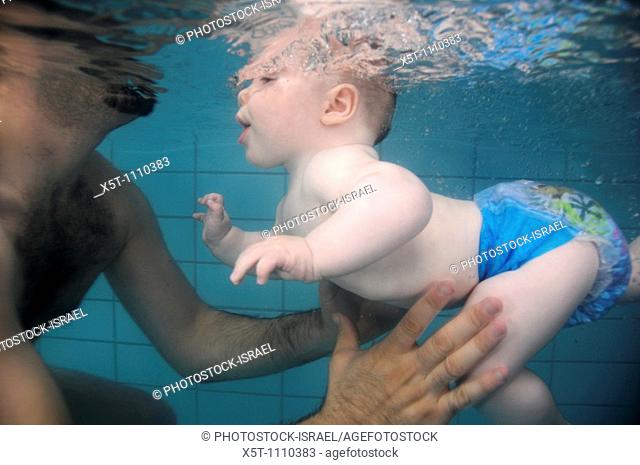 Baby boy of 6 months in a swimming pool