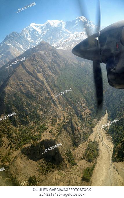 Annapurna range viewed through the window of a small twin otter aircraft. Nepal, Gandaki, flight between Pokhara and Jomsom in Mustang