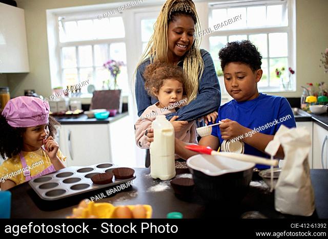 Mother and kids baking in kitchen