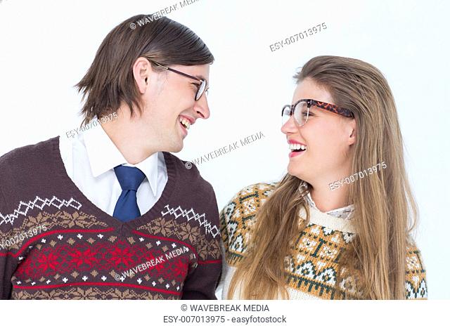 Happy geeky hipster couple looking at each other